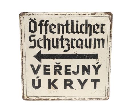 A SECOND WORLD WAR AIR RAID SHELTER SIGN. An air raid sign in German and Czech 'Public Shelter' in black against a white grou