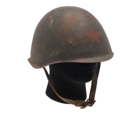 A SECOND WORLD WAR RUSSIAN M42 HELMET. An M42 pattern Russian helmet with original dark green painted surface and five pointe
