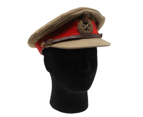 A FIRST WORLD WAR GENERAL'S PEAKED CAP. A Khaki peaked cap with red band with General's insignia to the centre, with a brown 