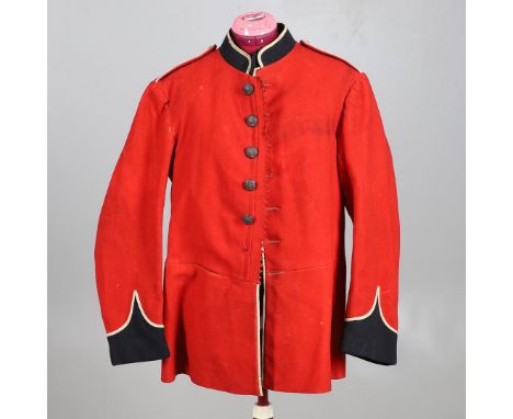 AN EARLY 20TH CENTURY SCARLET TUNIC WITH GENERAL SERVICE BUTTONS. An early 20th century scarlet tunic with remains of paper l