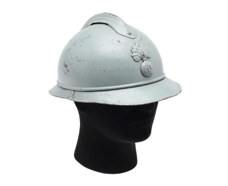 A FIRST WORLD WAR FRENCH ADRIAN HELMET. An M15 Pattern Adrian Helmet with RE grenade badge to the front. Stamped internally D