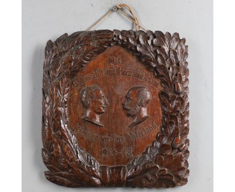 A FIRST WORLD WAR PRISONER OF WAR GERMAN CARVED PANEL. A carved panel worked with two side profile portraits in German 'With 