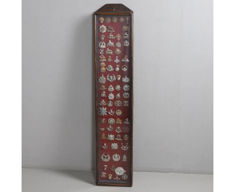 A FRAMED COLLECTION OF SEVENTY ONE CAP BADGES FOR BRITISH ARMY INFANTRY REGIMENTS. A good collection of British Infantry cap 