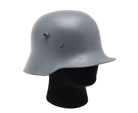 A FIRST WORLD WAR GERMAN M16 PATTERN HELMET SHELL. An M16 pattern steel helmet shell later spray painted in light grey. Marke