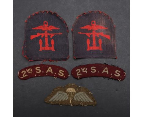 TWO 2ND S.A.S. SHOULDER TITLES AND TWO OTHER CLOTH BADGES. Two 2nd S.A.S. cloth shoulder patches, Army jump wings and two com
