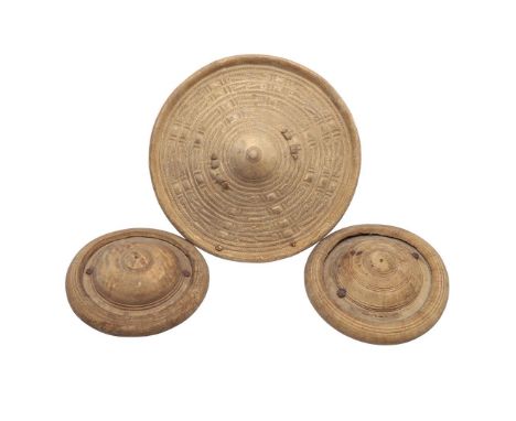 A SOMALI HIDE SHIELD AND TWO SMALLER SHIELDS. A circular shield with raised centre and woven type decoration, hand grip to th