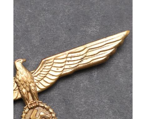 A GERMAN ARMY GENERAL'S BREAST EAGLE. Gilt brass type with broad outstretched wings and swastika in laurel wreath, with long 