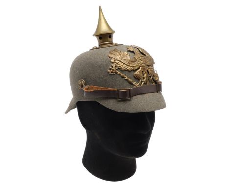 A FIRST WORLD WAR FELT PRUSSIAN PICKELHAUBE. A grey felt Pickelhaube with raised central spike on plate with four dome topped
