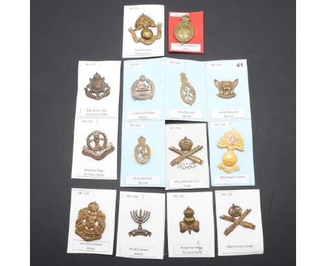 A COLLECTION OF CAP BADGES FOR FIRST WORLD WAR RAISED BATTALIONS. A collection of fourteen cap badges for the Royal Irish Rif