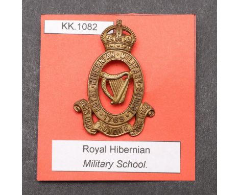 A ROYAL HIBERNIAN MILITARY SCHOOL CAP BADGE. A 1901-21 period die stamped Royal Hibernian Military School Cap badge with Impe