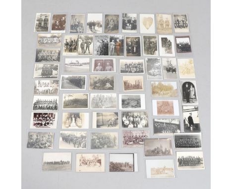 A COLLECTION OF FIFTY POSTCARDS OF FIRST WORLD WAR AND LATER GROUPS OF SOLDIERS IN UNIFORM. An interesting collection of fift
