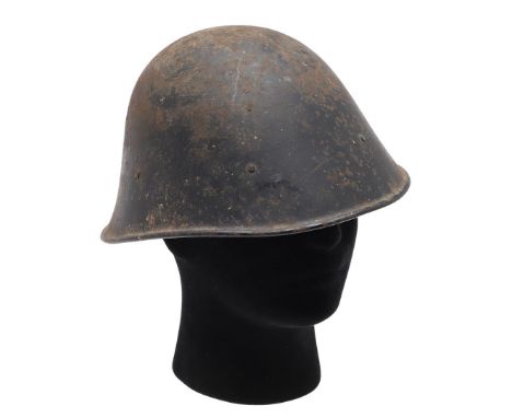 A SECOND WORLD WAR DUTCH HELMET. A Second World War Dutch combat helmet with black painted surface, with internal liner. In b