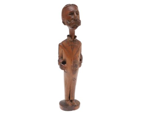 A NOVELTY PIPE AND STAND IN THE FORM OF A MAN WITH ELABORATE MUSTACHE. A carved wooden novelty pipe and stand, possibly a lik