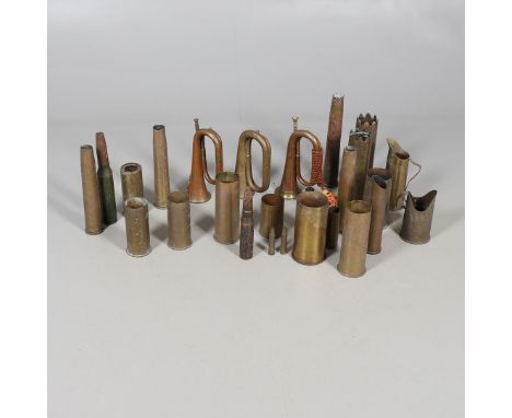 A BRASS AND COPPER BUGLE WITH ROYAL WELSH FUSILIERS BADGE, TWO OTHERS AND A COLLECTION OF TRENCH ART. Three military type bug