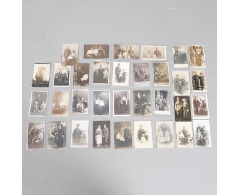 A COLLECTION OF THIRTY THREE POSTCARDS OF FIRST WORLD SOLDIERS IN UNIFORM WITH FAMILY MEMBERS. An interesting collection of p