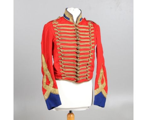 A FINELY TAILORED SCARLET, BLUE AND GILT HUSSARS JACKET AND CAP. A scarlet Hussars type jacket with gilt braid trim and dark 