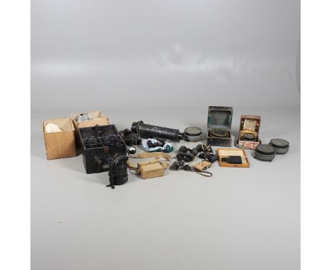 A COLLECTION OF MILITARY ISSUE BINOCULARS, COMPASSES AND SIMILAR ITEMS. A large Air Ministry aerial camera lens with Referenc