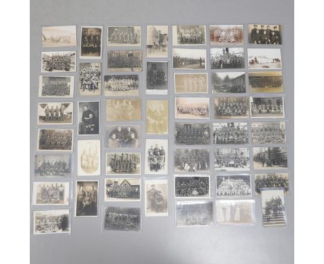 A COLLECTION OF FIFTY POSTCARDS OF FIRST WORLD WAR AND LATER GROUPS OF SOLDIERS IN UNIFORM. An interesting collection of fift