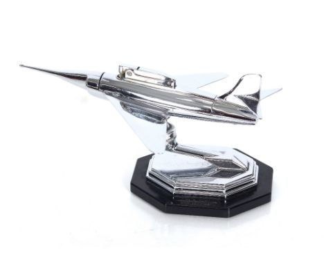 A chrome lighter in the form of a fighter jet, the plinth stamped "Gala-Sonic Made In England"