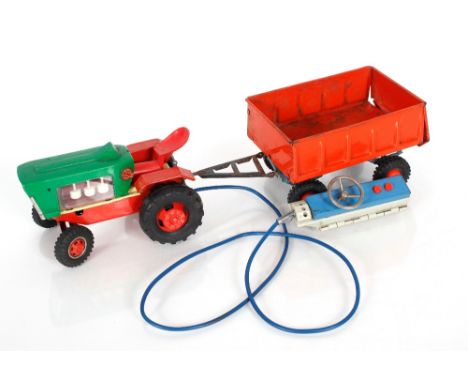 A tin plate toy tractor and trailer by Gama of Germany