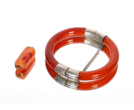 A hardstone and white metal mounted snap bangle and a small hardstone pendant