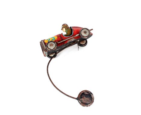 A shelf hanging tin plate model racing car and driver 