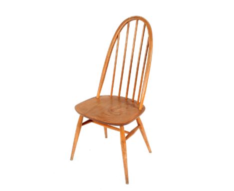 A set of four arched stick back Ercol dining chairs