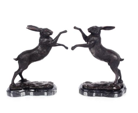 A pair of bronze boxing hares, 30cm high