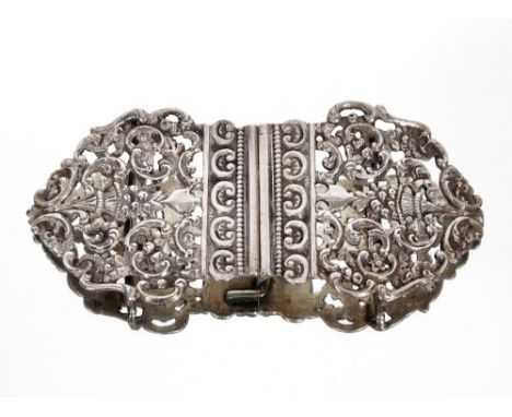 A late Victorian silver nurses buckle with foliate pierced decoration, probably London 1897; and a silver snap bangle