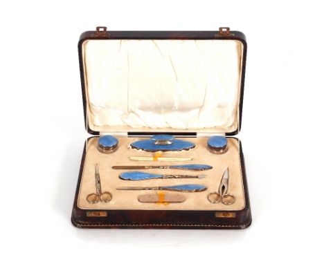 A cased silver and enamel part manicure set