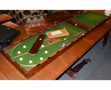 A 19th century mahogany folding bar bagatelle table with two cues and nine balls&nbsp;