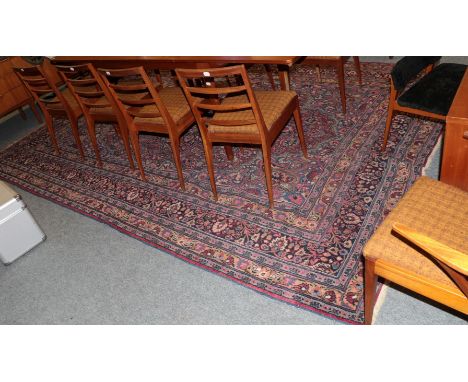 A Mashad carpet, the raspberry field with flower head medallion enclosed by multiple borders, 367cm by 260cm 