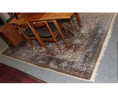 A large Kashmir carpet, the floral field with central medallion framed by spandrels of multiple borders, 290cm by 195cm