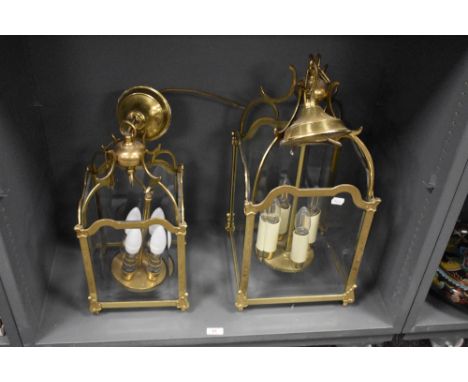 A pair of 20th Century four sided glass and brass framed lantern light fittings, each measuring 50cm tall