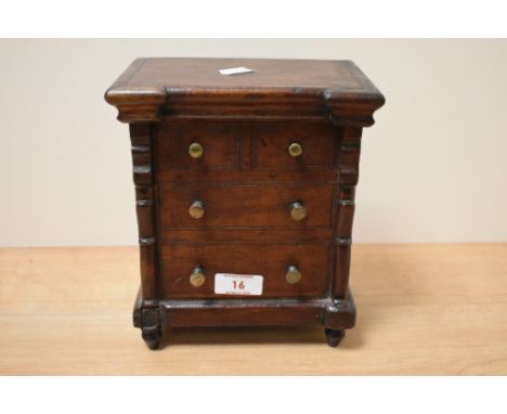 A Victorian mahogany tobacco box, with interior tin lining, modelled as a Scotch chest of drawers, measuring 21cm tall