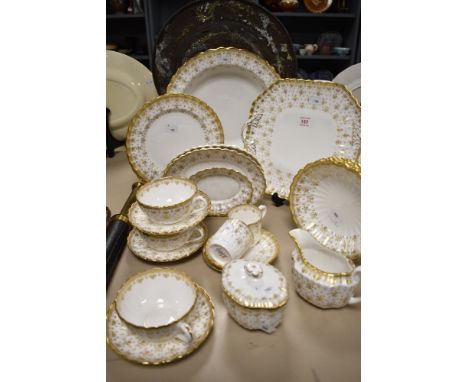A selection of Spode 'Fleur de  Lys Gold', comprising; deep large dish, plates, bowls, jug, sugar, cups and saucers etc.