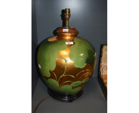 A 20th Century Chinese gold/gilt lustre lamp base, of spherical form, and raised on a hardwood stand, measuring 50cm tall