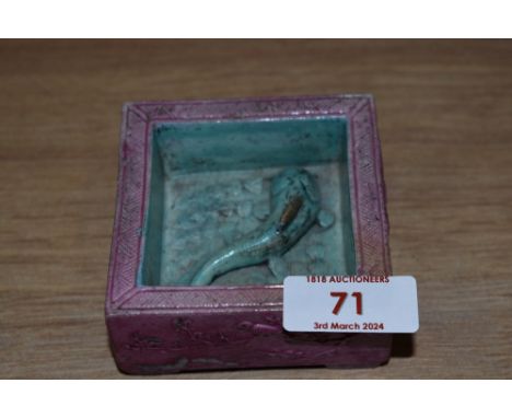 An Oriental square ceramic ashtray or trinket pot, having pink and blue ground with raised Koi carp to bottom.
some loss to g