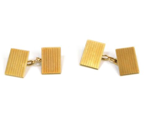 A pair of 9ct gold cufflinks, each rectangular shield with engine turned decoration, maker OP, Birmingham 1913, in Bright and
