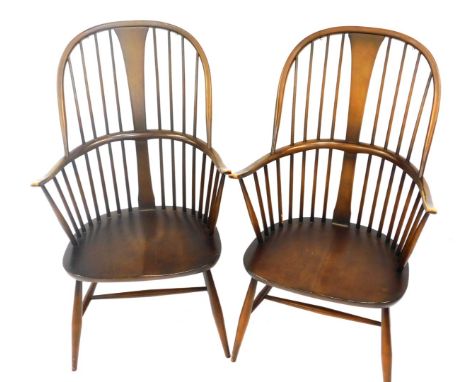 A pair of Ercol mid brown stained ash and elm Windsor armchairs, each with spindle turned back, solid seat, on H stretcher. 