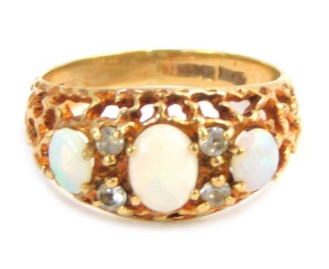 A 9ct gold dress ring, set with opals and cz, on a pierced and mottled effect setting, size M½, 3.4g all in. 