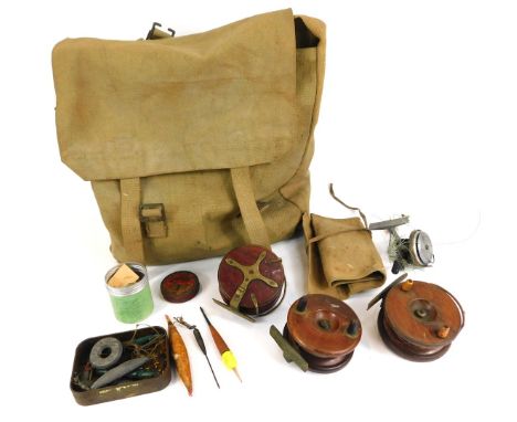 A group of fishing tackle, comprising vintage wooden reels, canvas travel sack, spool, etc. (a quantity) 