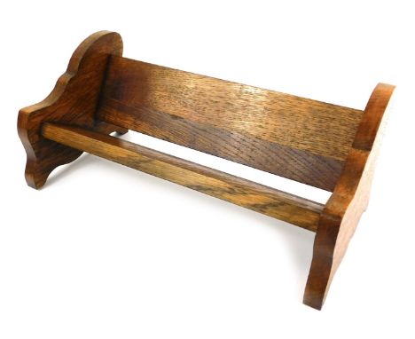An early 20thC oak book trough, with shaped ends, 41cm wide. 