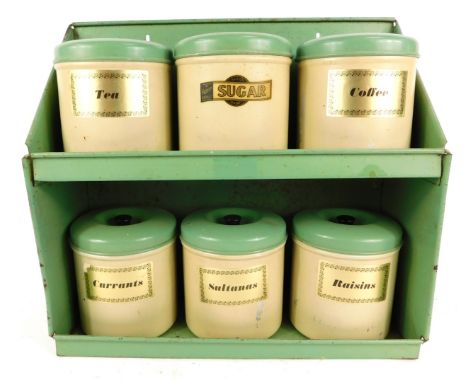 A mid Century enamel kitchen storage shelf, with jars for Raisins, Coffee, Sultanas, Currants, Sugar, and Tea, each jar 11cm 