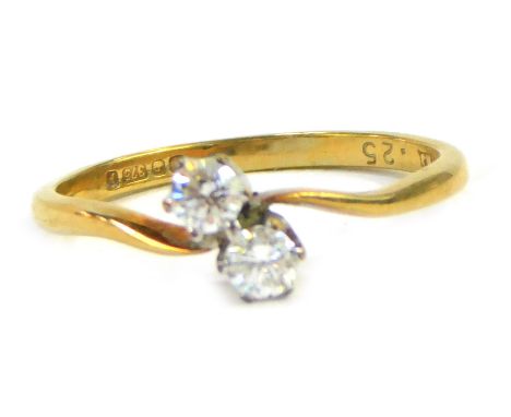 A 9ct gold two stone twist ring, set with two tiny diamonds, totalling approximately 0.25ct, ring size M½, 1.4g all in.