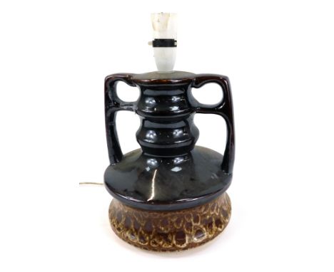 A Western German style mottled brown table lamp, of twin handled bulbous form, 30cm high. Buyer Note: WARNING! This lot conta