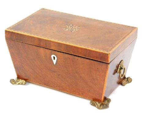 A Georgian mahogany and inlaid tea caddy, the marquetry inlaid lid opening to reveal two compartments flanking a mixing bowl 