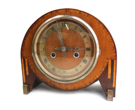 An Art Deco walnut and rosewood inlaid mantel clock, the circular dial with silvered chapter ring bearing Roman numerals, eig