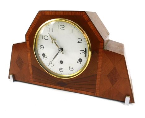 A 1950s walnut cased Art Deco style mantel clock, the circular white dial bearing Arabic numerals, eight day movement with We