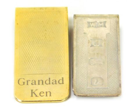 An Elizabeth II silver paperclip, with engine turned decoration, Birmingham 1995, 0.47oz, and a brass paperclip, engraved Gra